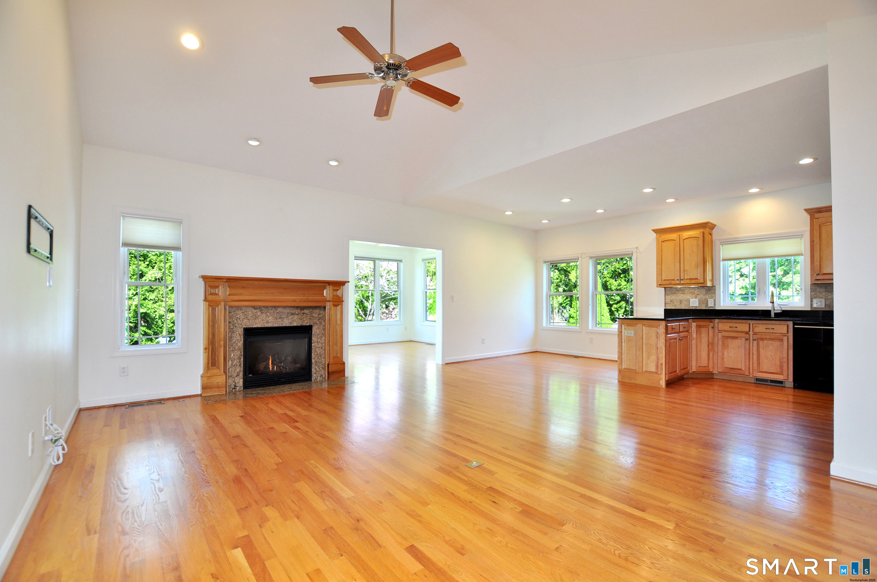 453 Tributary Lane Windsor, CT 06095 - Photo 8 of 37 a view of an empty room with kitchen and a fireplace