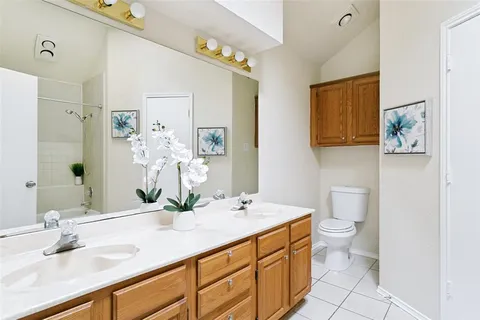 a bathroom with a double vanity sink and a mirror