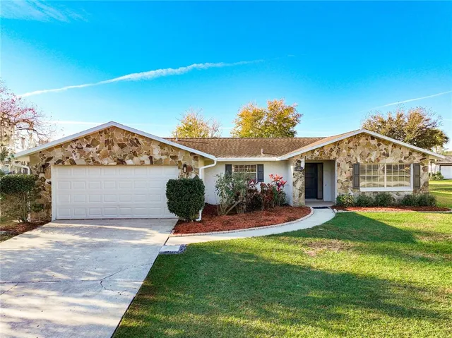 a view of a house with a yard and sitting area