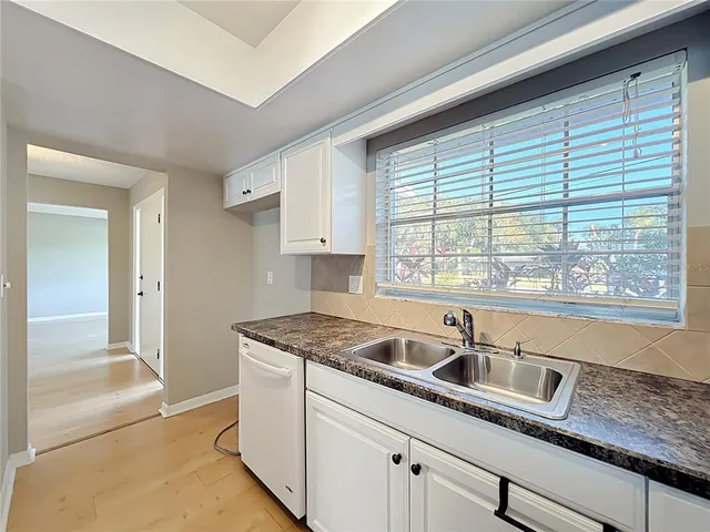 a kitchen with granite countertop a sink and a window