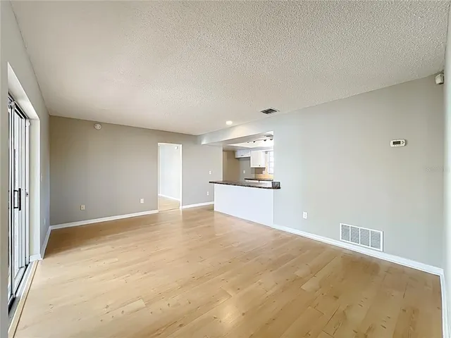 a view of a kitchen with a sink and a refrigerator