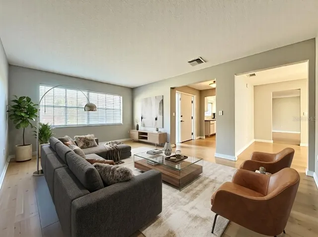 a living room with furniture and a large window