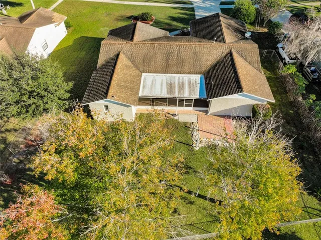 an aerial view of a city with lots of residential buildings ocean and mountain view in back