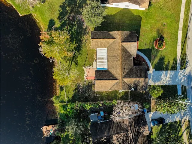 an aerial view of a city with lots of residential buildings ocean and mountain view in back