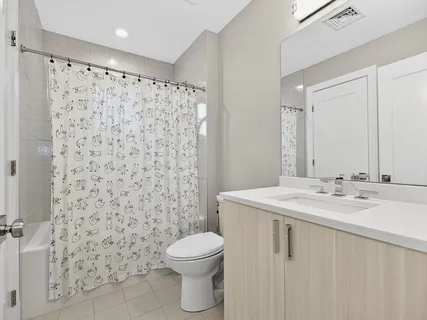 a bedroom with a large bed and a flat tv screen