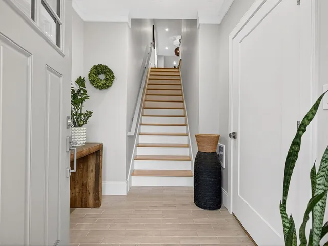 a view of entryway and hall with wooden floor