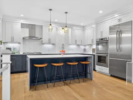 a kitchen with stainless steel appliances granite countertop a stove a sink and a refrigerator