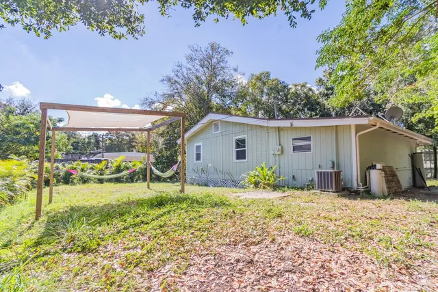 a backyard of a house with table and chairs