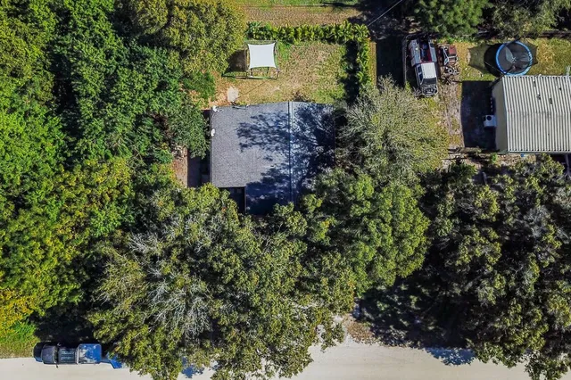 a view of house with backyard and garden