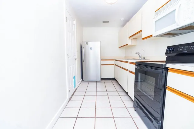 a kitchen with stainless steel appliances granite countertop a refrigerator and a stove