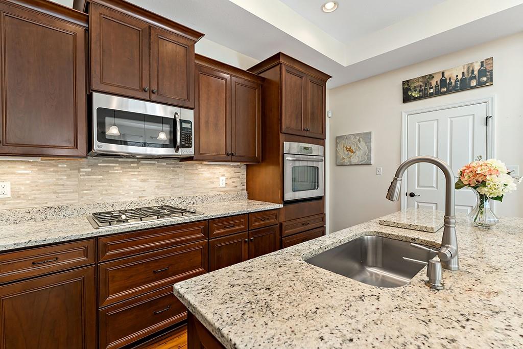 137 Cobblestone Drive Pittsburgh, PA 15237 - Photo 10 of 39 a kitchen with granite countertop a stove microwave and sink
