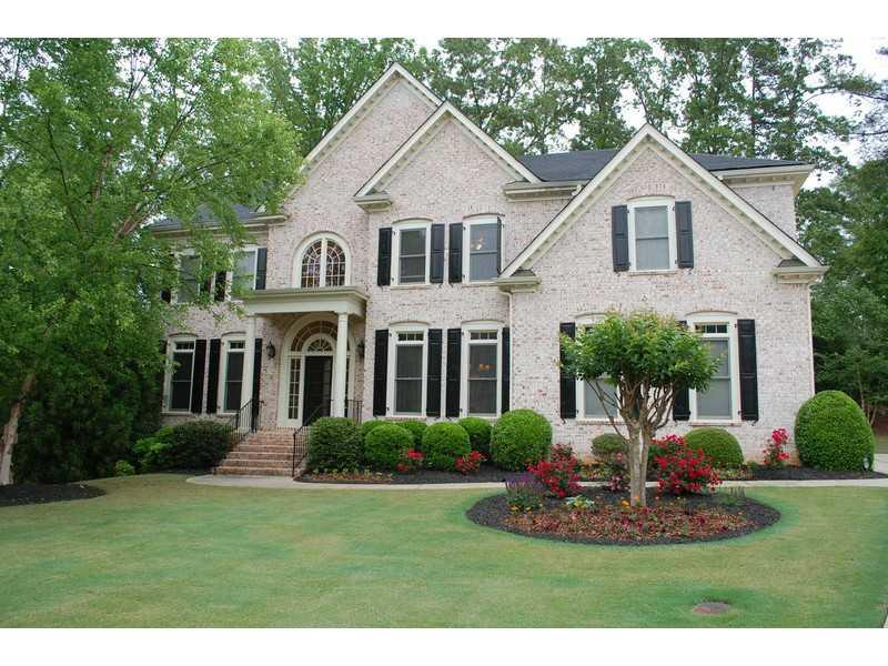 8940 Muirfield Court Duluth, GA 30097 - Photo 1 of 1 a front view of a house with a yard
