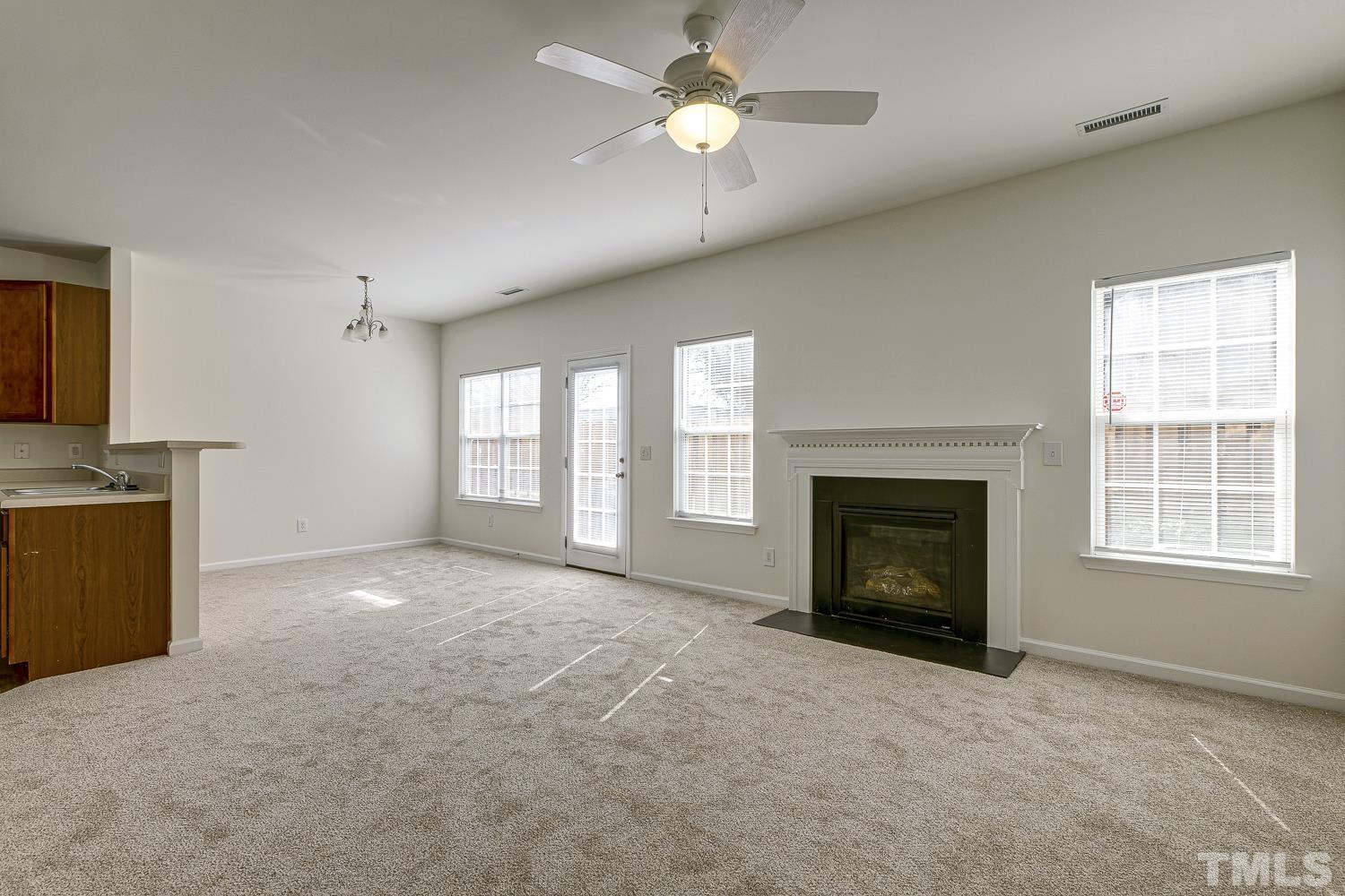 3132 Manhasset Lane Raleigh, NC 27604 - Photo 5 of 10 a view of empty room with a fireplace and fan