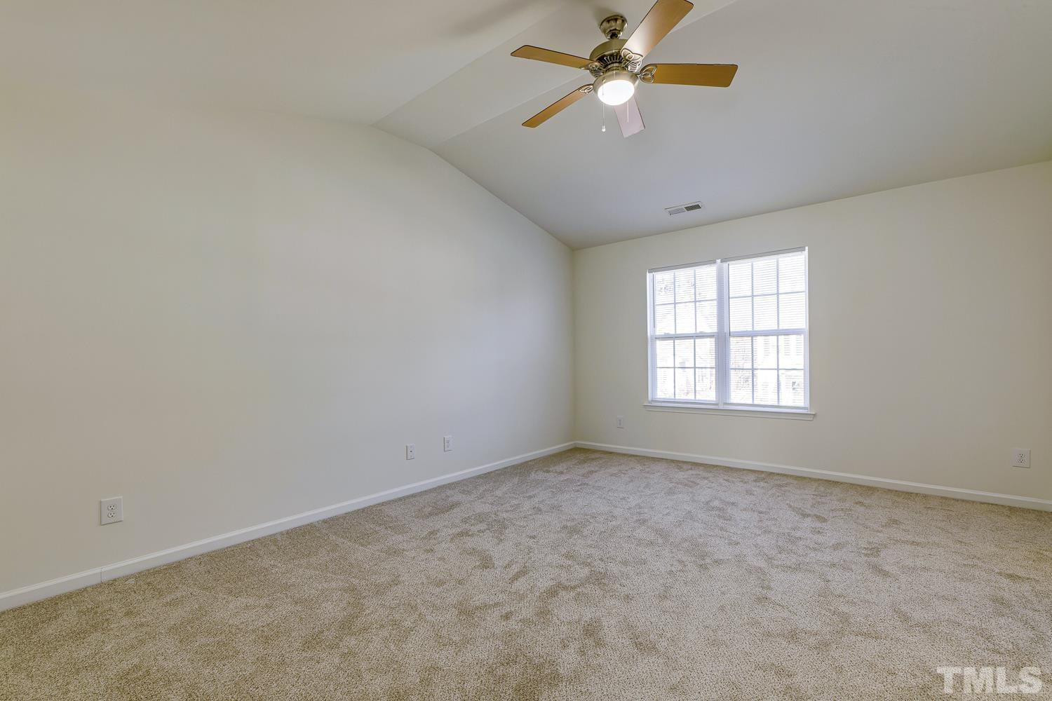 3132 Manhasset Lane Raleigh, NC 27604 - Photo 6 of 10 an empty room with a window and a fan