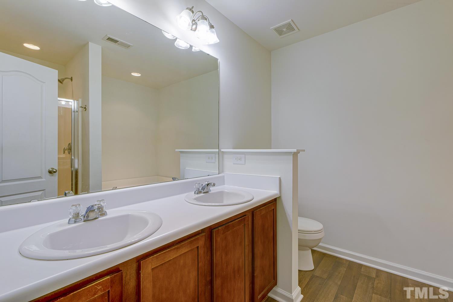 3132 Manhasset Lane Raleigh, NC 27604 - Photo 8 of 10 a bathroom with a sink a toilet and shower