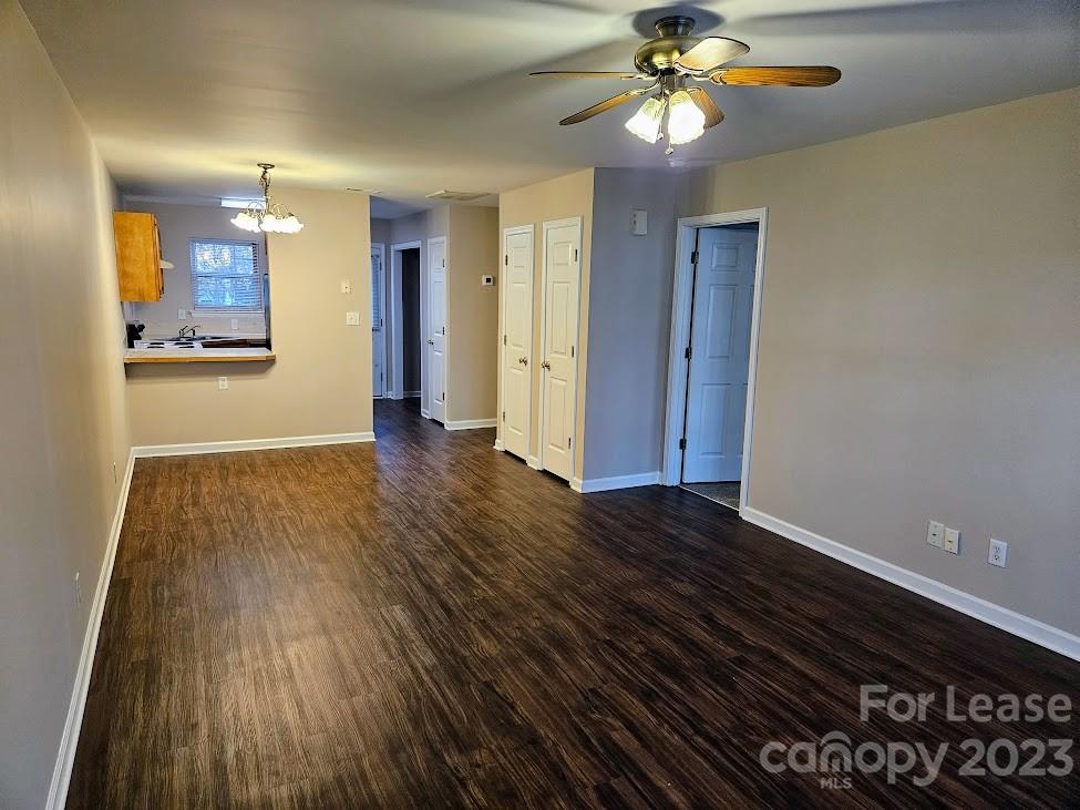 1205 Auten Road, Unit B Charlotte, NC 28216 - Photo 3 of 14 a view of a hallway with wooden floor and a chandelier