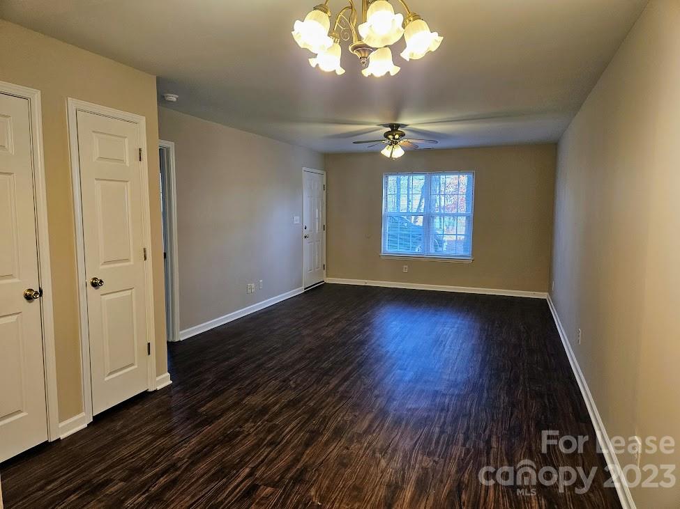 1205 Auten Road, Unit B Charlotte, NC 28216 - Photo 4 of 14 an empty room with wooden floor chandelier and windows