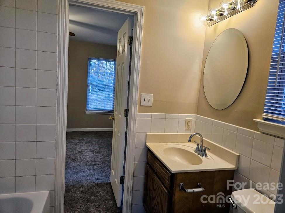 1205 Auten Road, Unit B Charlotte, NC 28216 - Photo 9 of 14 a bathroom with a sink and a mirror