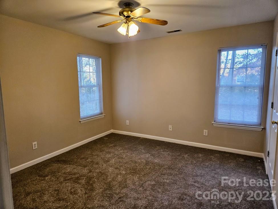 1205 Auten Road, Unit B Charlotte, NC 28216 - Photo 10 of 14 an empty room with windows and fan