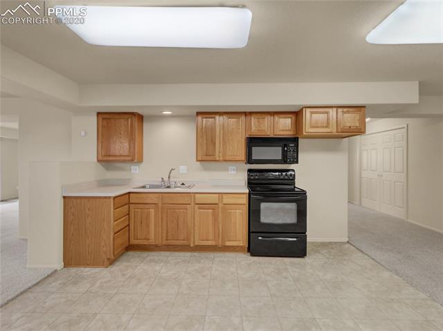 8599 Tibbs Road Peyton, CO 80831 - Photo 28 of 38 Another view of the 2nd kitchen in the basement area (refrigerator not included)