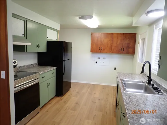 a kitchen with granite countertop stainless steel appliances and wooden cabinets