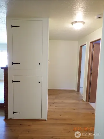 an empty room with wooden floor and closet