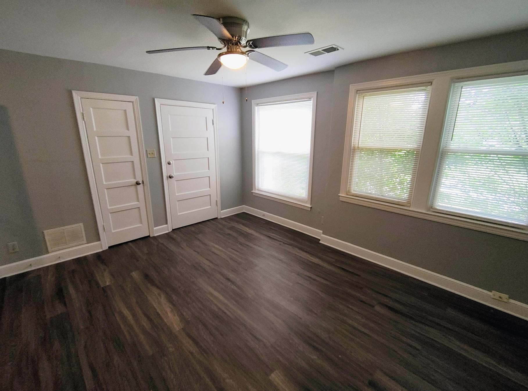 1271 Carrolton Road Memphis, TN 38127 - Photo 6 of 11 Empty room with ceiling fan and dark wood finished floors