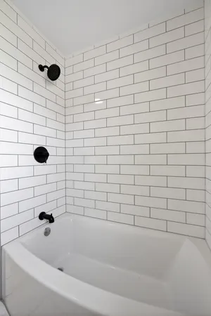 a bathroom with a shower and a bathtub
