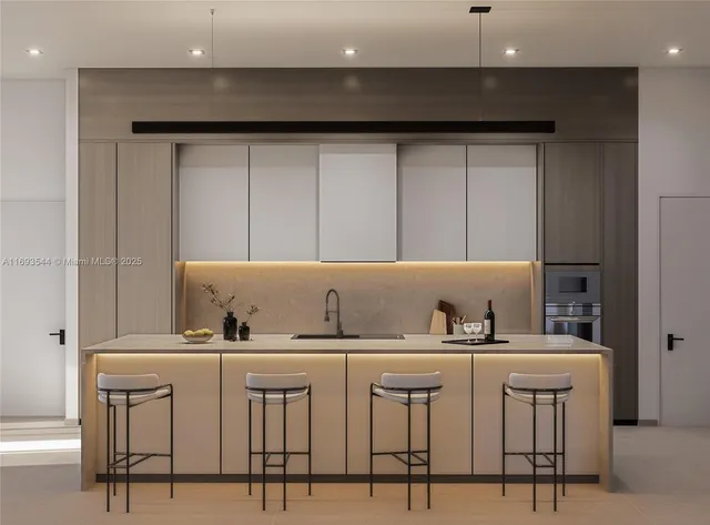 a kitchen with cabinets and chairs