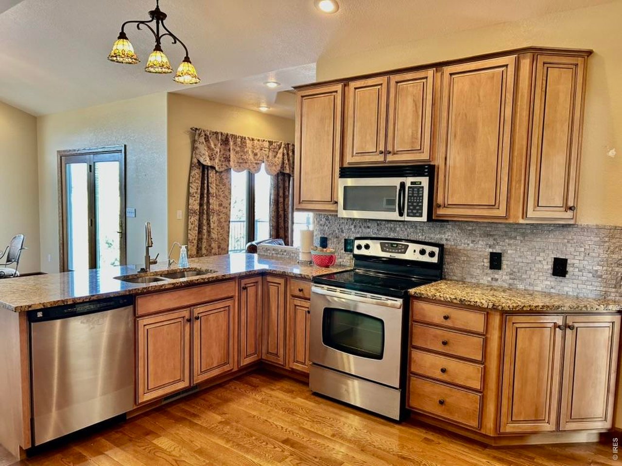 131 Club Road Sterling, CO 80751 - Photo 11 of 50 a kitchen with stainless steel appliances granite countertop a stove sink and cabinets