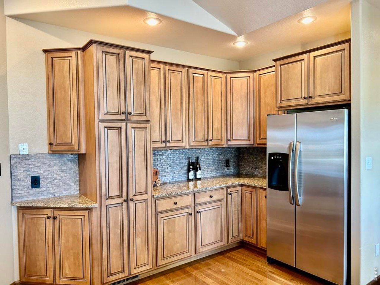 131 Club Road Sterling, CO 80751 - Photo 12 of 50 a kitchen with stainless steel appliances granite countertop a refrigerator and cabinets