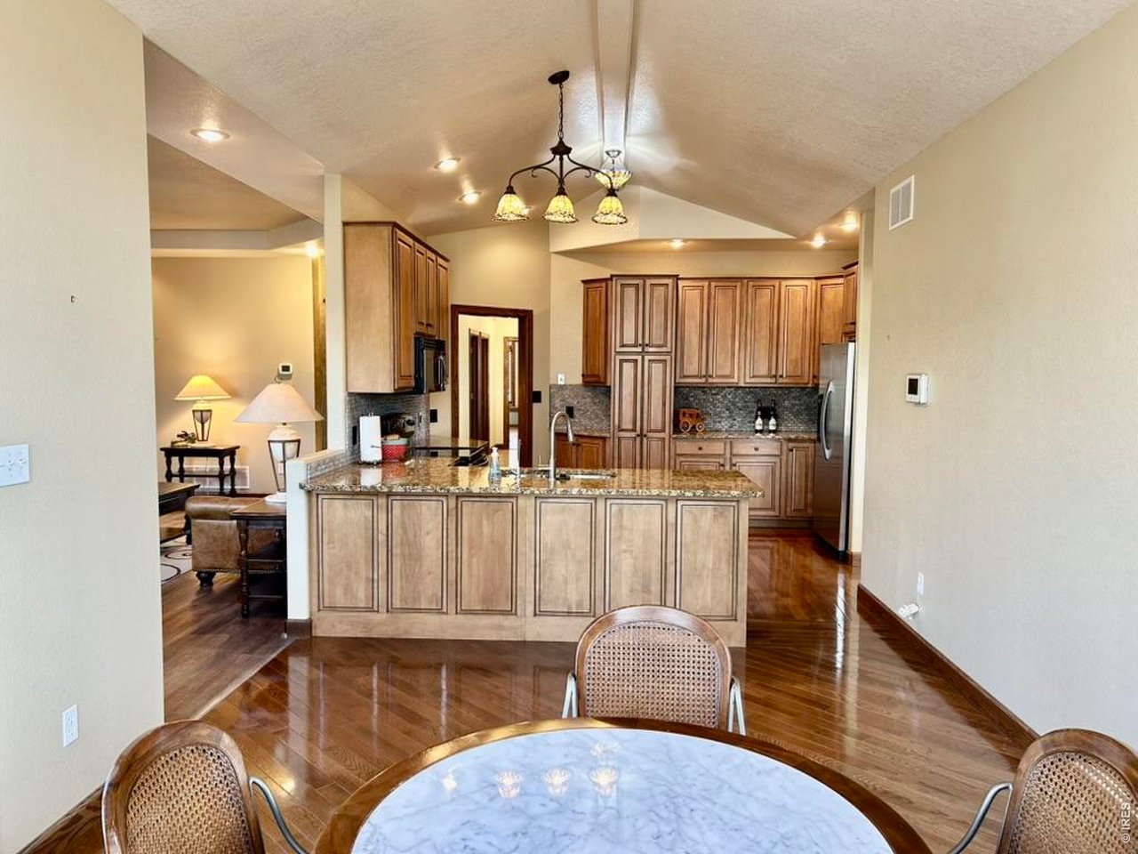 131 Club Road Sterling, CO 80751 - Photo 17 of 50 a living room with furniture a chandelier and a dining table