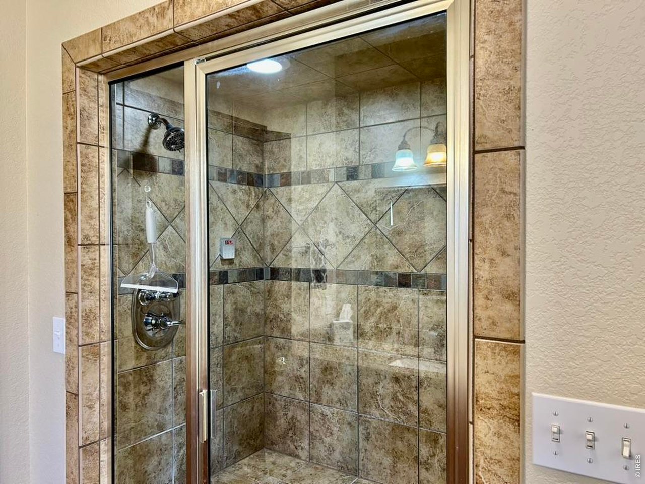 131 Club Road Sterling, CO 80751 - Photo 32 of 50 a bathroom with a glass shower door