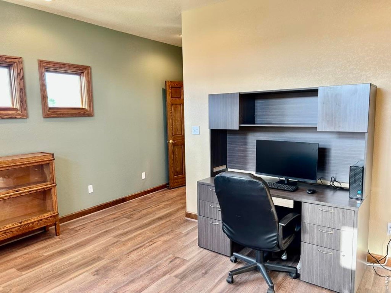 131 Club Road Sterling, CO 80751 - Photo 38 of 50 a workspace with furniture and wooden floor