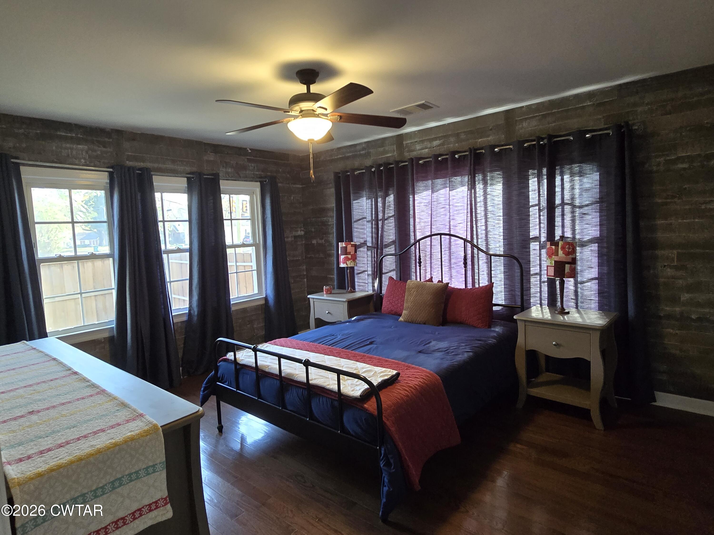 232 Russell Road Jackson, TN 38301 - Photo 23 of 30 a bedroom with a bed wooden floor and window