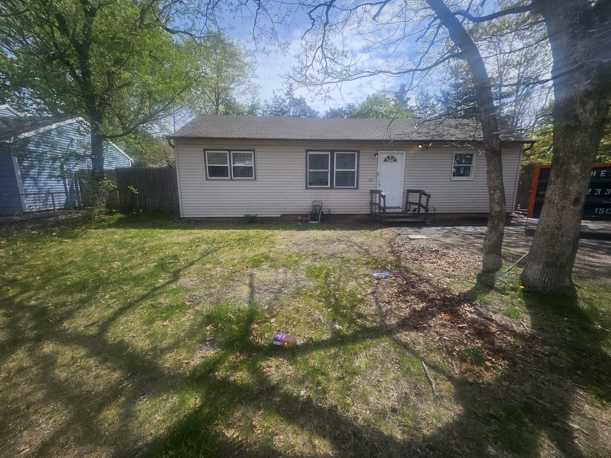 Undisclosed Address Ridge, NY 11961 - Photo 1 of 1 View of front of house with a front lawn and fence