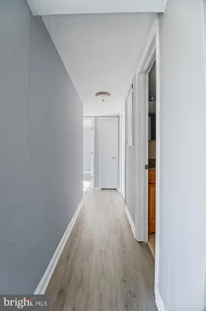 a view of a hallway with wooden floor
