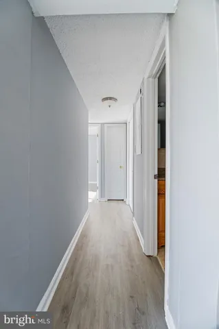 a view of a hallway with wooden floor