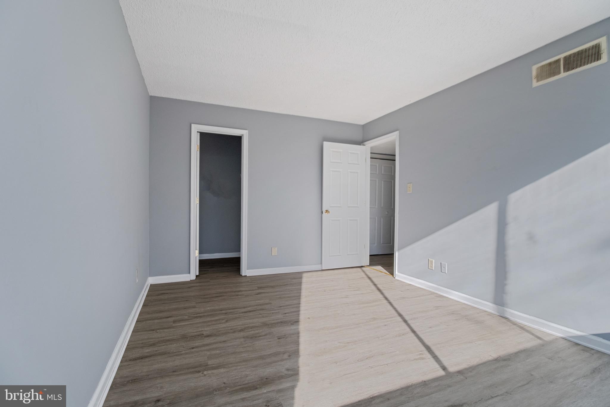 1822 Metzerott Road, Unit 205 Adelphi, MD 20783 - Photo 15 of 21 a view of an empty room with wooden floor