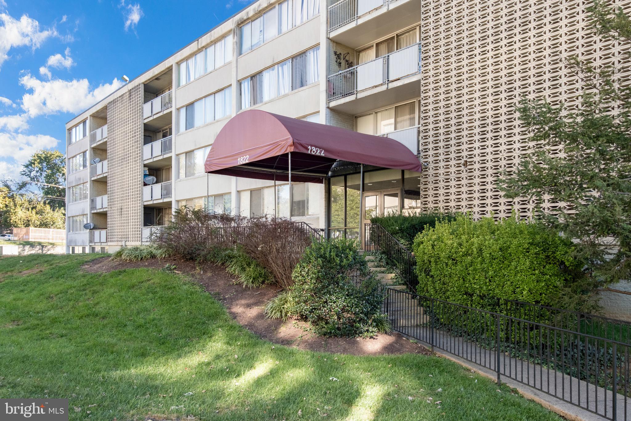 1822 Metzerott Road, Unit 205 Adelphi, MD 20783 - Photo 18 of 21 a front view of a building with a garden