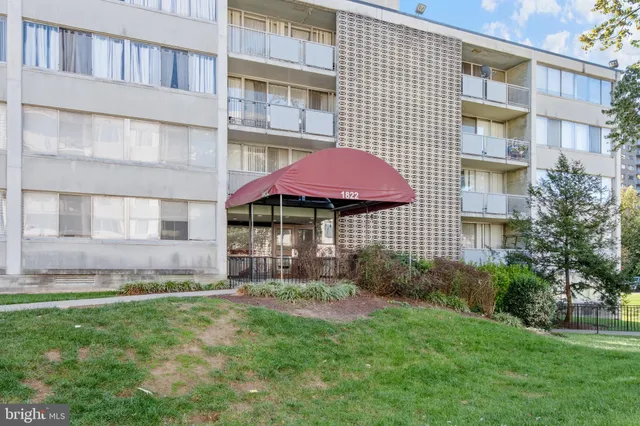 a front view of a building with a garden