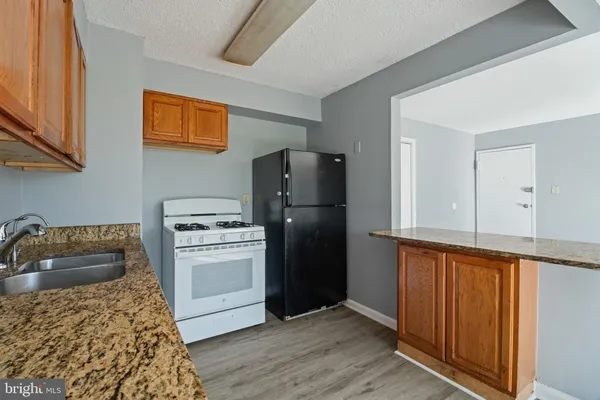 a kitchen with a refrigerator stove and sink
