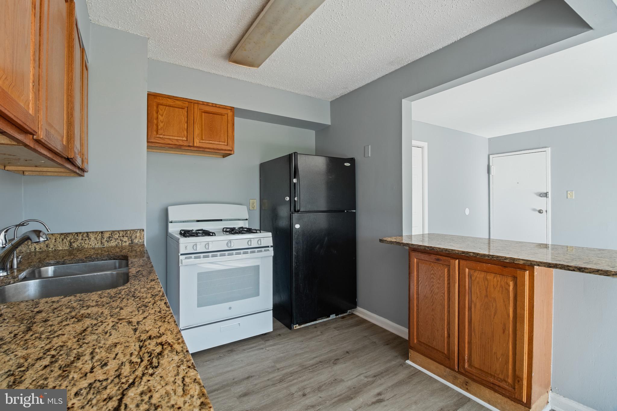 1822 Metzerott Road, Unit 205 Adelphi, MD 20783 - Photo 3 of 21 a kitchen with a refrigerator stove and sink