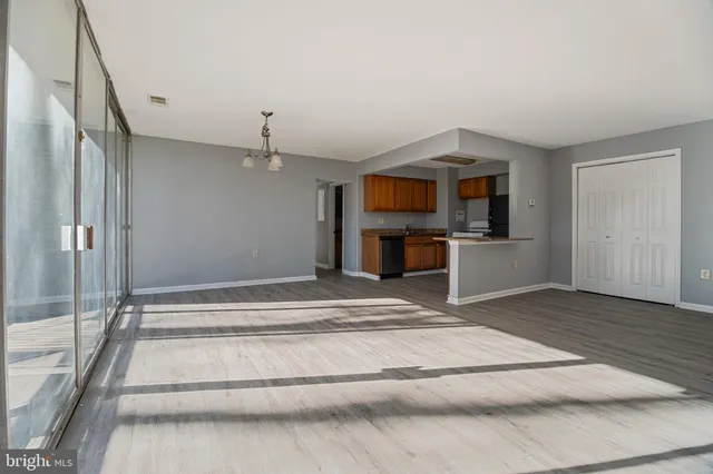 a spacious bedroom with a bed and a flat screen tv