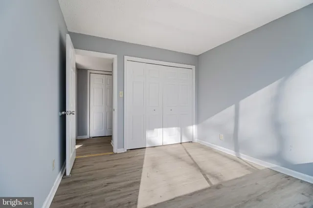 wooden floor in a hall with an empty room