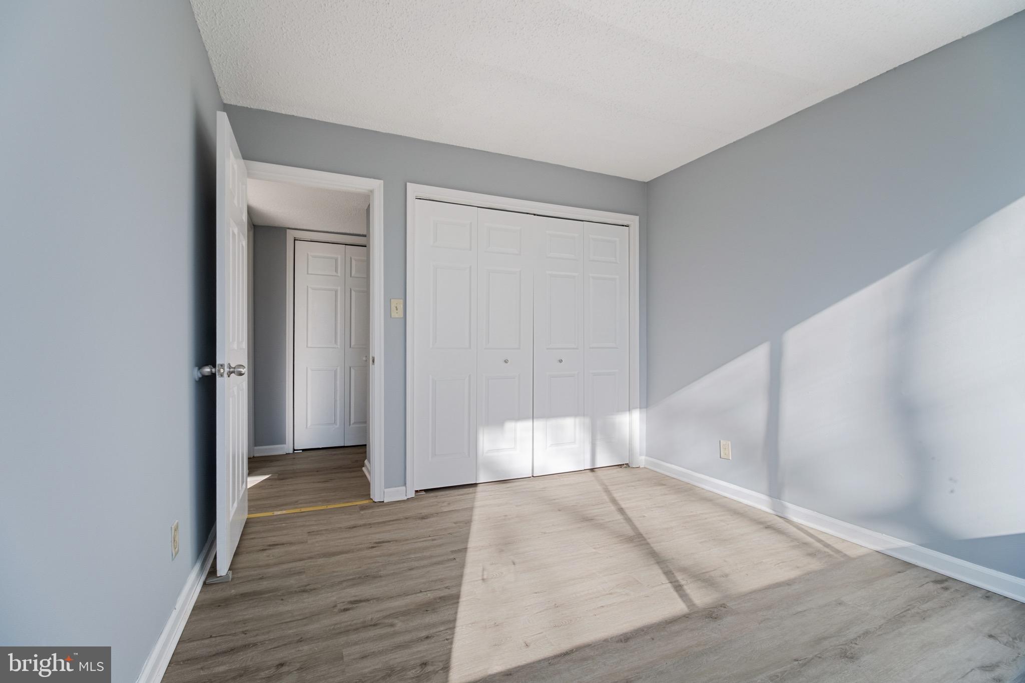 1822 Metzerott Road, Unit 205 Adelphi, MD 20783 - Photo 8 of 21 wooden floor in a hall with an empty room