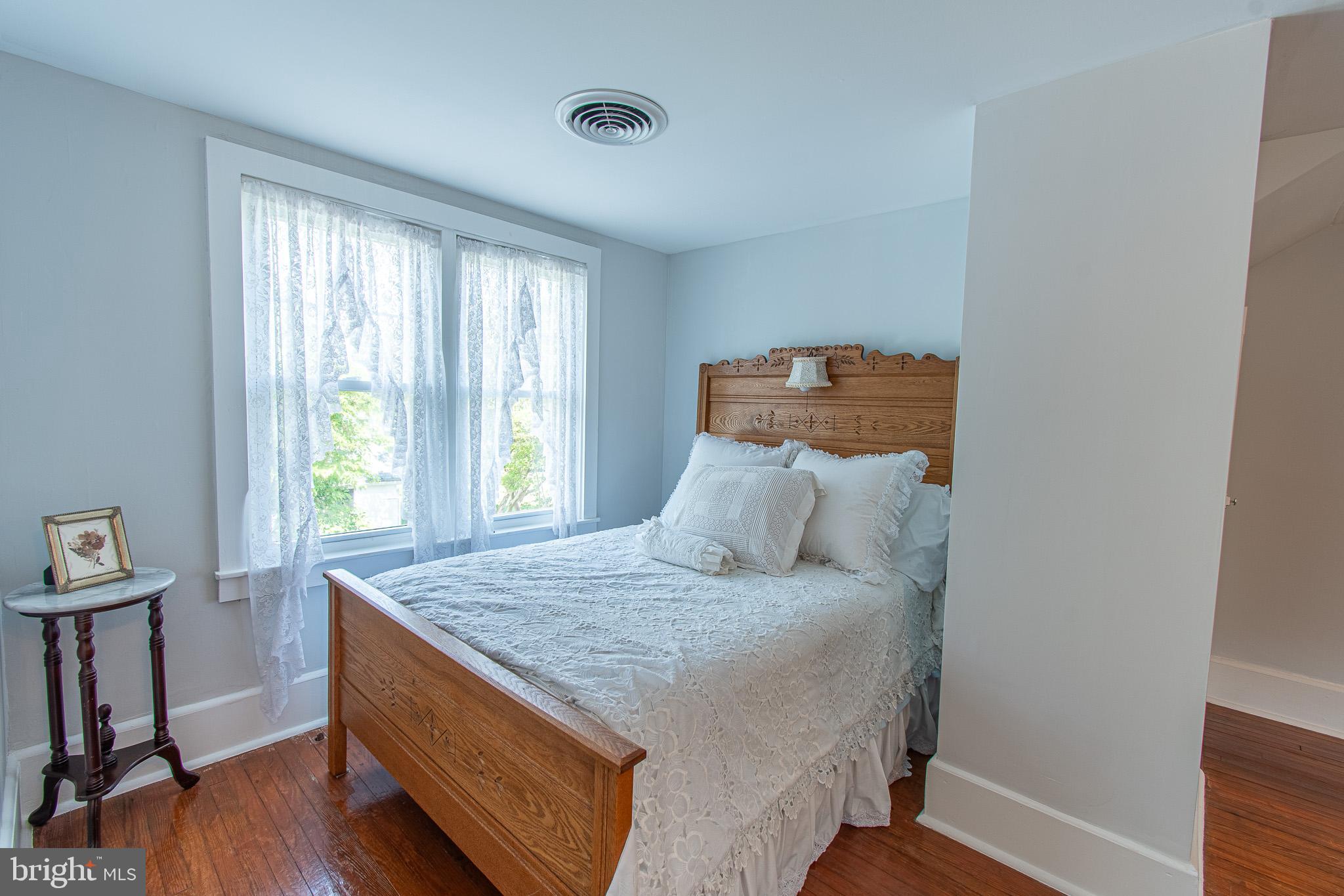 207 Crusader Road Cambridge, MD 21613 - Photo 44 of 76 a bedroom with a bed and wooden floor