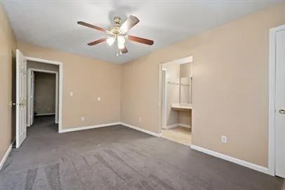 an empty room with closet and windows