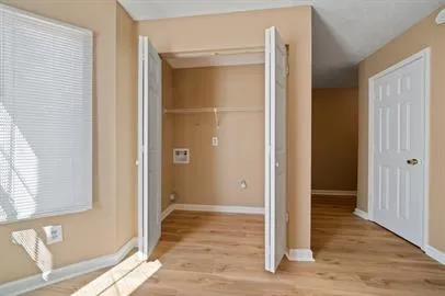 a view of an empty room with wooden door