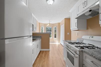 7253 Crestside Drive Austell, GA 30168 - Photo 5 of 14 a kitchen with a stove a refrigerator and a cabinets